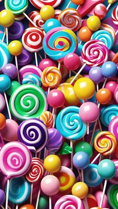 many colorful lollipops are stacked on top of each other in this image