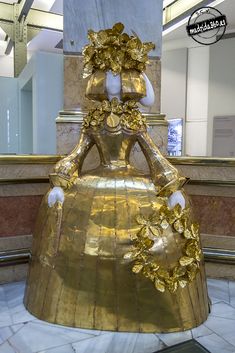 a large golden statue in the middle of a room