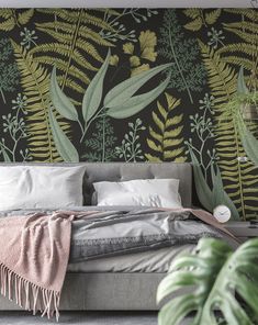 a bed sitting under a green leafy wallpaper next to a plant filled wall