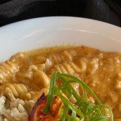 pasta with shrimp and tomato in a white bowl