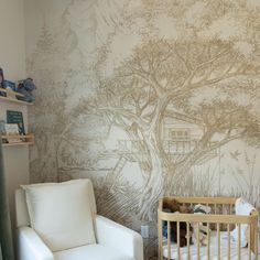 a baby's room with a tree mural on the wall and a crib