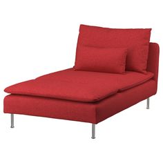 a red couch with two pillows on top of it and one arm extended to the side