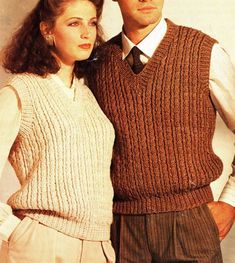 a man and woman standing next to each other wearing sweaters, vests and ties