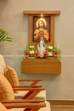 an image of jesus on the wall above a shrine with flowers and candles in front of it