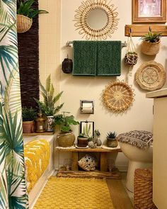 a bathroom with plants and towels hanging on the wall