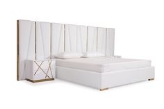 a white bed sitting next to a wooden headboard