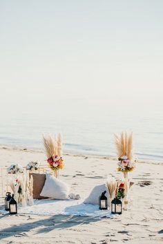 an outdoor ceremony set up on the beach with pamodia and pamodia flowers