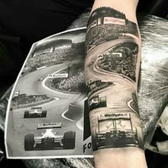 a person with a tattoo on their arm is holding a magazine and some cars are driving down the road