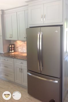 a stainless steel refrigerator in a white kitchen