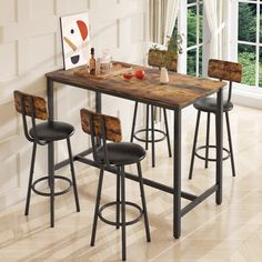 a kitchen table with four stools in front of it and a painting on the wall