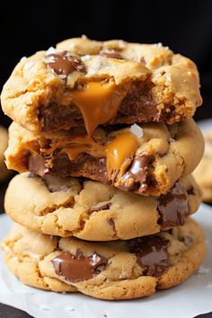 chocolate chip cookies stacked on top of each other with caramel sauce drizzled over them