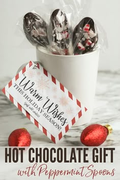 hot chocolate gift with peppermint spoons in a white cup on a marble surface