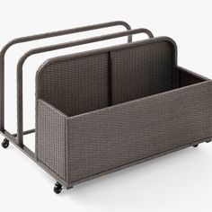 a gray wicker basket with wheels and two bins on the bottom one is empty