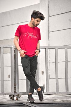 a man in a red shirt is skateboarding