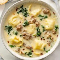 a white bowl filled with soup and some bread