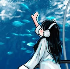 a girl with headphones is looking at the water