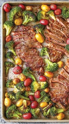 steak, broccoli and tomatoes on a baking sheet