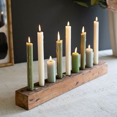 a group of candles sitting on top of a wooden stand