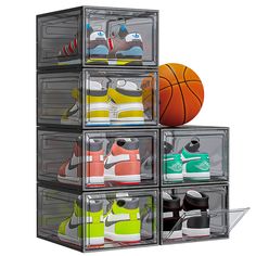 four clear storage bins with different shoes in them and a basketball ball on top