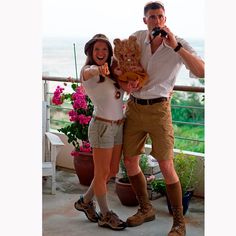 a man and woman posing for a photo on a balcony