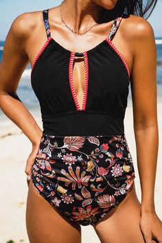 Step into summer with our Floral & Black Halter Stitch One-Piece. This stunning swimsuit combines feminine floral patterns with sleek black for a timeless yet contemporary look. The halter neckline adds an elegant touch while providing support, making it perfect for lounging by the pool or strolling along the shore. Product code: CAA12E4D185AA Features:  Halter neckline Cross back straps Removable soft cups Back tie Stitching Standard cut leg  Classic standard bum coverage Pattern: Floral Lining Summer Black Printed Swimwear, Black Printed Swimwear For Summer, Black Lined Swimwear For Beach, Black Lined Swimwear For The Beach, Black Halter Neck Swimwear With Lined Body, Black Floral Print Swimwear For Beach, Black Halter Neck Swimwear For Poolside, Lined Black Swimwear For Pool, Black Halter Neck Tankini For Summer