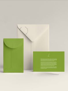 two envelopes and one card with the letter s on it, both in green