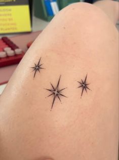 a woman's back with three stars on it