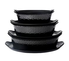 four black dishes stacked on top of each other