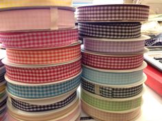 several different colored ribbons stacked on top of each other in front of a computer keyboard