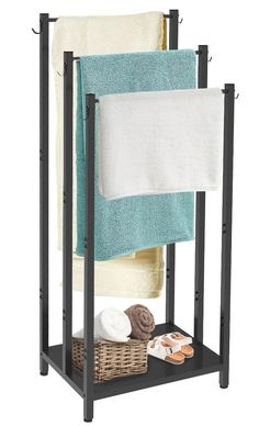 a towel rack with two towels on it and a basket next to it, in front of a white background