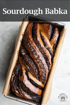 a loaf of sourdough babka in a baking pan