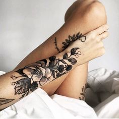 a woman's arm with flowers on it