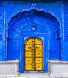 an ornate blue building with yellow doors