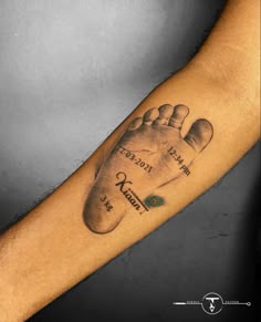 a man's arm with a tattoo on it that has a hand and foot