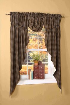 the window is decorated with brown and white checkered curtains, an old chest of drawers and a potted plant