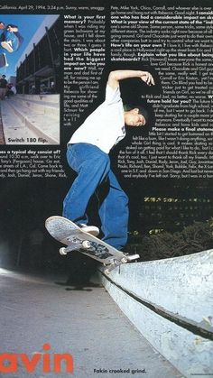 a man riding a skateboard up the side of a cement wall in front of a building