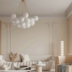 a living room filled with white furniture and lots of balloons hanging from the ceiling above