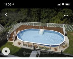 an above ground swimming pool with deck and stairs