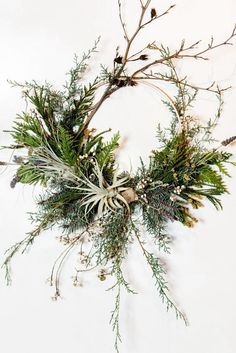 a wreath made out of branches and pine cones