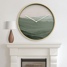 a clock on the wall above a fireplace