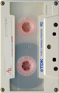 two white cassettes with pink tape on them