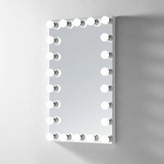 a mirror that is on the wall with lights