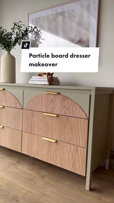 an image of a dresser with drawers on it and a plant in the corner next to it