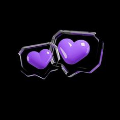 two purple heart shaped glasses sitting next to each other on top of a black surface