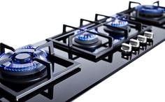 a black gas stove with blue burners on it