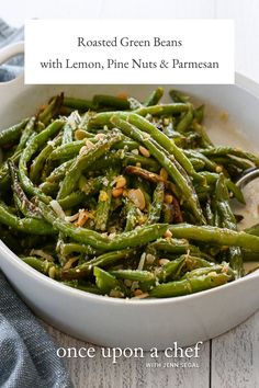 roasted green beans with lemon, pine nuts and parmesan in a white bowl