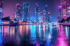 Vibrant cityscape at night with neon lights reflection stock images Cityscape At Night, High Rise Buildings, City Night, Bustling City, Night View, Night Scene, The Calm, Anime Scenery Wallpaper, Neon Blue