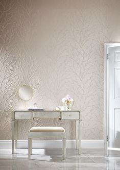 a white desk with a mirror and flowers on it