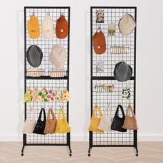 two metal racks with hats and purses hanging from them on the wall next to each other