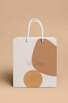 a brown and white shopping bag with the word bronze in gold on it's front